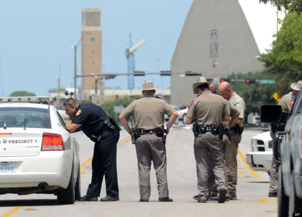 On The Scene - Texas State troopers and Brazos Valley lawmen work the scene of the shooting of two fellow law officers, Monday, Aug. 13, 2012 in College Station, Texas. Police say at least one law enforcement officer and one civilian have been killed in a shooting near Texas A&M University's campus. Assistant Chief Scott McCollum says the gunman also was shot Monday before being taken into custody. (AP Photo/College Station Eagle, Dave McDermand)