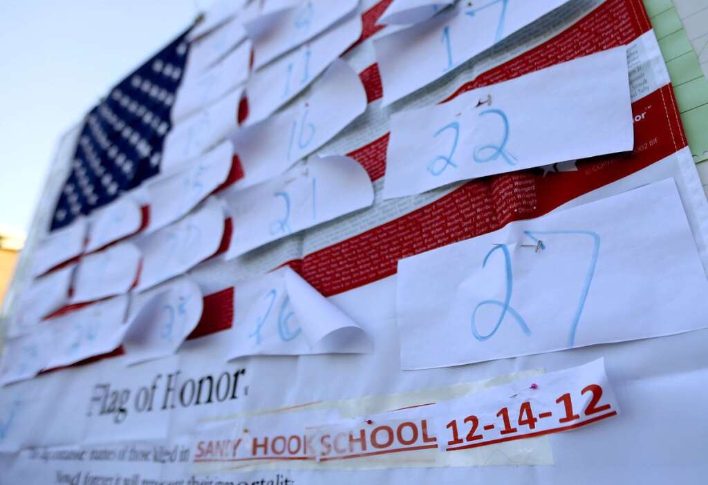Sandy Hook Elementary School Shooting - A U.S. flag is covered with numbers representing the people that died when a gunman opened fired at Sandy Hook Elementary School during a shooting rampage a day earlier, Saturday, Dec. 15, 2012, in Sandy Hook village of Newtown, Conn. The massacre of 26 children and adults at Sandy Hook Elementary school elicited horror and soul-searching around the world even as it raised more basic questions about why the gunman, 20-year-old Adam Lanza, would have been driven to such a crime and how he chose his victims. (AP Photo/Julio Cortez)