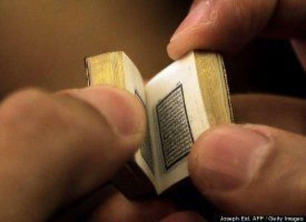 - Hassan Abed Rabbo inspects what he says is the smallest handwritten, complete version of the Koran ever made. The 2.4-by-1.9-centimeter Muslim holy book, which Rabbo inherited from his great-grandmother, contains 604 pages decorated with gold ink. Guinness officials currently recognize a Koran that measures 1.7 centimeters by 1.28 centimeters, owned by Muhammad Karim Beebani, as the world's smallest Koran -- though his version of the religious text isn't handwritten.