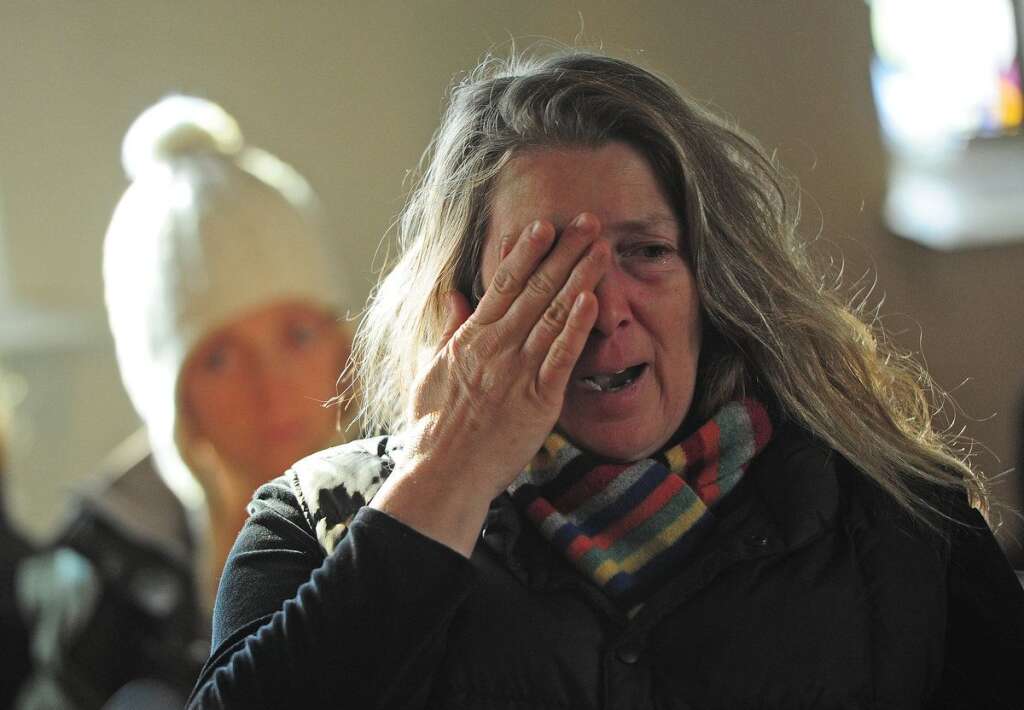 Sandy Hook Elementary School Shooting - A woman cries during a prayer service at St. John's Episcopal Church following an elementary school shooting in Newtown, Connecticut, on December 15, 2012.  A young gunman slaughtered 20 small children and six teachers on December 14 after walking into a school in an idyllic Connecticut town wielding at least two sophisticated firearms.   AFP PHOTO/Emmanuel DUNAND
