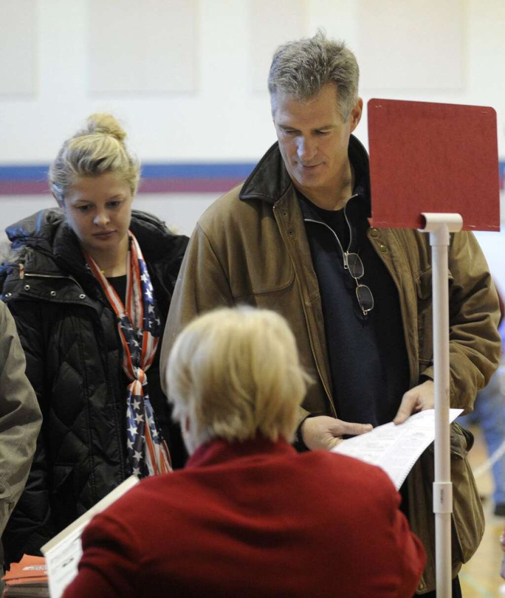 Scott Brown - U.S. Sen. Scott Brown, R-Mass., picks up his ballot with his daughter Arianna, left, to cast his vote in Wrentham, Mass., on Election Day, Tuesday, Nov. 6, 2012. Brown is facing Democratic candidate Elizabeth Warren for the U.S. Senate. (AP Photo/Gretchen Ertl)