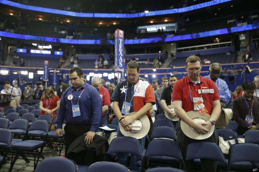 Delegates from Texas pray during an abbreviated session of the Republican National Convention in Tampa, Fla., on Monday, Aug. 27, 2012. (AP Photo/Charles Dharapak)