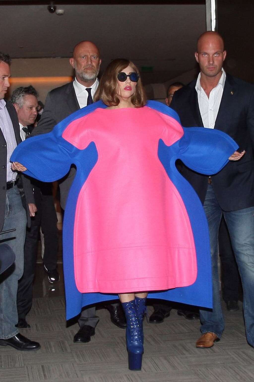 Démesurée - Lady Gaga porte une robe volumineuse bicolore signée Comme des Garçons, à la sortie de l'hôtel Vendôme, à Paris. Des bottes à grandes plates-formes et des lunettes noires complètent ce look déjanté. On aime le jeu de superposition de la robe et le rouge à lèvres assorti. (Le 22 septembre 2012)