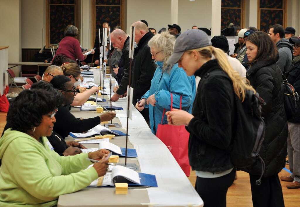 US-VOTE-2012-ELECTION DAY - Election officials verify addresses of voters at the polling station at Metropolitan AME Church  in Washington, DC on November 6, 2012. Americans headed to the polls Tuesday after a burst of last-minute campaigning by President Barack Obama and Mitt Romney in a nail-biting contest unlikely to heal a deeply polarized nation. AFP PHOTO/Mladen ANTONOV        (Photo credit should read MLADEN ANTONOV/AFP/Getty Images)