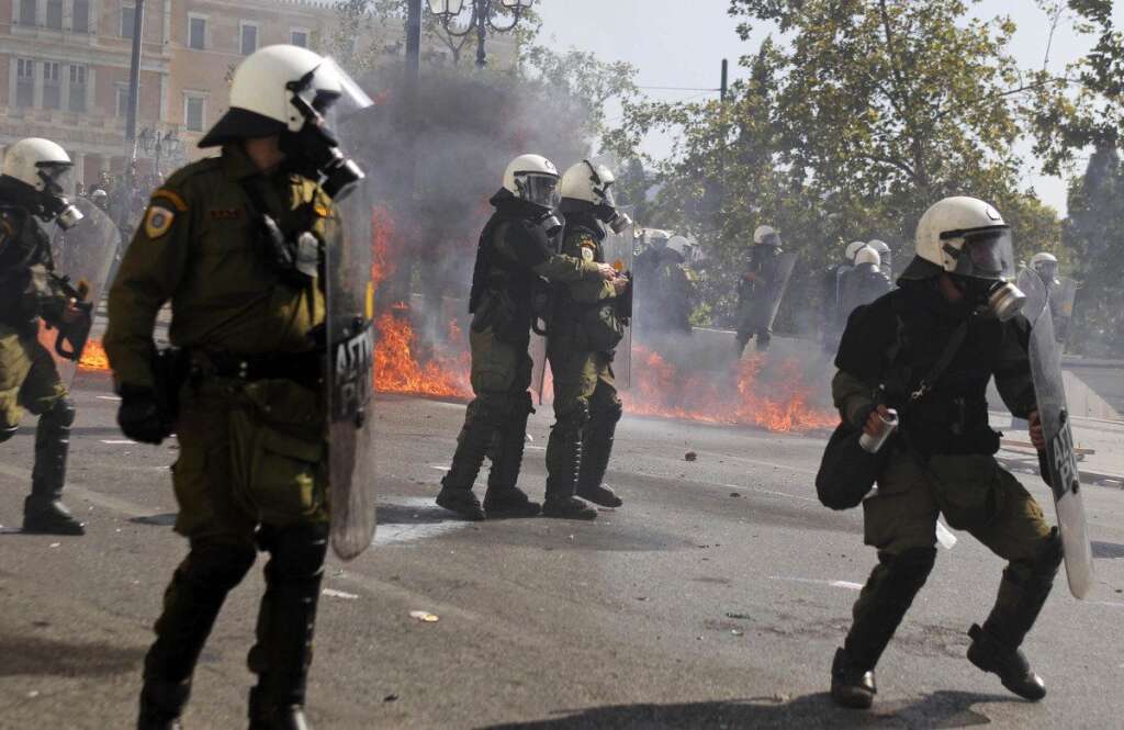 - Riot police try to avoid petrol bombs thrown by protesters during clashes during the 24-hour nationwide general strike on Thursday, Oct. 18, 2012. Hundreds of youths pelted riot police with petrol bombs, bottles and chunks of marble Thursday as yet another Greek anti-austerity demonstration descended into violence. (AP Photo/Petros Giannakouris)