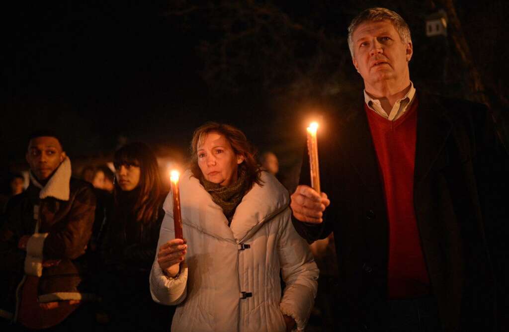 Sandy Hook Elementary School Shooting - People gather for a prayer vigil at St Rose Church following an elementary school shooting in Newtown, Connecticut, December 14, 2012.  A young gunman slaughtered 20 small children and six teachers on Friday after walking into a school in an idyllic Connecticut town wielding at least two sophisticated firearms AFP PHOTO/Emmanuel DUNAND
