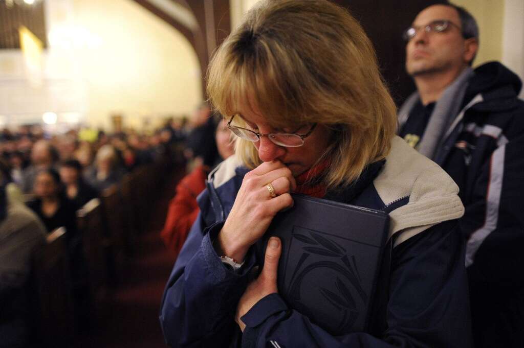 Sandy Hook Elementary School Shooting - Mourners gather at a vigil service for victims of the Sandy Hook Elementary School shooting, at the St. Rose of Lima Roman Catholic Church in Newtown, Conn. Friday, Dec. 14, 2012. A man killed his mother at their home and then opened fire Friday inside Sandy Hook Elementary School, massacring 26 people, including 20 children, as youngsters cowered in fear to the sound of gunshots reverberating through the building and screams echoing over the intercom (AP Photo/Andrew Gombert, Pool)