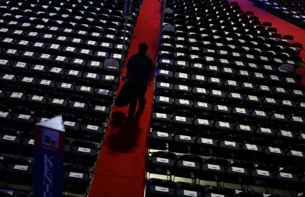 A worker walks down the isle to collect trash on the floor at the Republican National Convention in Tampa, Fla., on Wednesday, Aug. 29, 2012. (AP Photo/David Goldman)