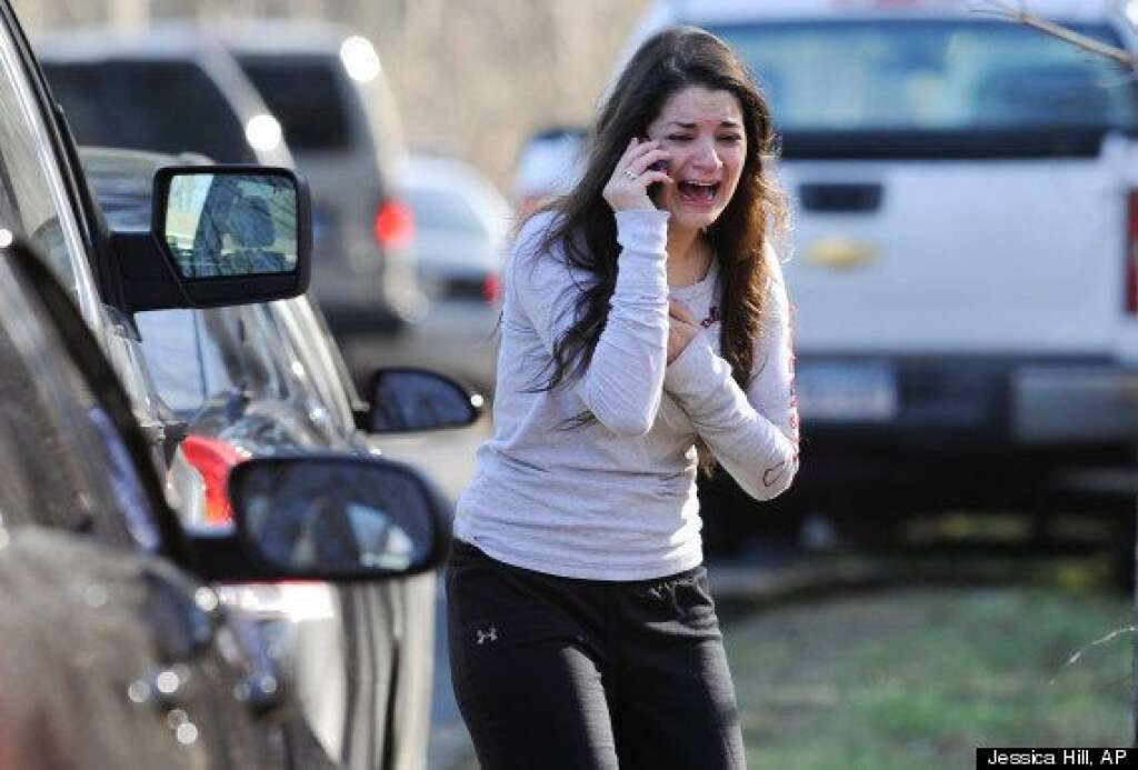 Sandy Hook Elementary School Shooting - Jillian Soto uses a phone to get information about her sister, Victoria Soto, a teacher at the Sandy Hook elementary school in Newtown, Conn. Friday, Dec. 14, 2012 after a gunman killed over two dozen people, including 20 children. Victoria Soto, 27, was among those killed. (AP Photo/Jessica Hill)