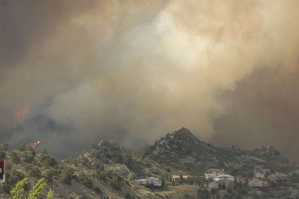 Western Wild Fires - Flames of the Waldo Canyon Fire races down into western portions of Colorado Springs, Colo. on Tuesday, June 26, 201. The flames approach a residential neighborhood heading north and leaving a trail of destruction, burning homes and buildings in it's path. Heavily populated areas in the fire's path have been affected. (AP Photo/Bryan Oller)