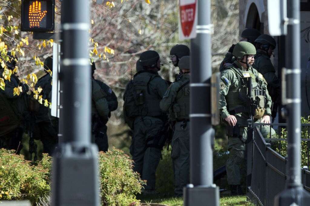 Brookfield Shooting - Swat team members gather outside of Azana Salon after a shooting in Brookfield, Wis., Sunday , Oct. 21, 2012. Deputies searched Sunday for a shooter after multiple people were wounded when someone opened fire at a spa near a suburban Milwaukee shopping mall. (AP Photo/Tom Lynn)