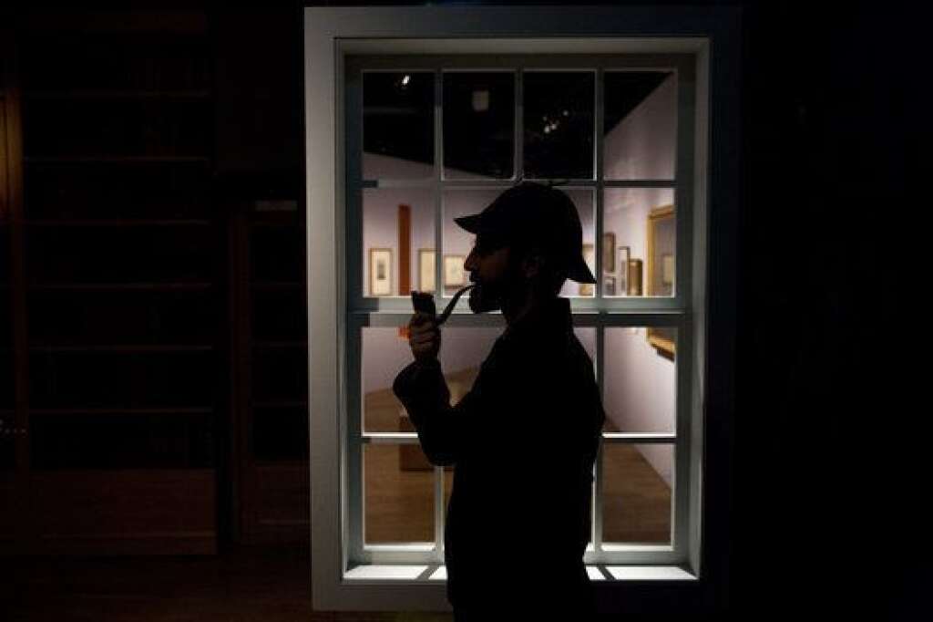 - Curator Timothy Long is silhouetted as he poses for photographers with a Sherlock Holmes style pipe and deerstalker hat beside an internal window forming part of the exhibition "Sherlock Holmes:  The Man Who Never Lived and Will Never Die" at the Museum of London in London, Thursday, Oct. 16, 2014. The exhibition, which opens to the public on Friday, is the largest on the fictional detective created by Scottish author Sir Arthur Conan Doyle to be held in the UK for 60 years  (AP Photo/Matt Dunham)
