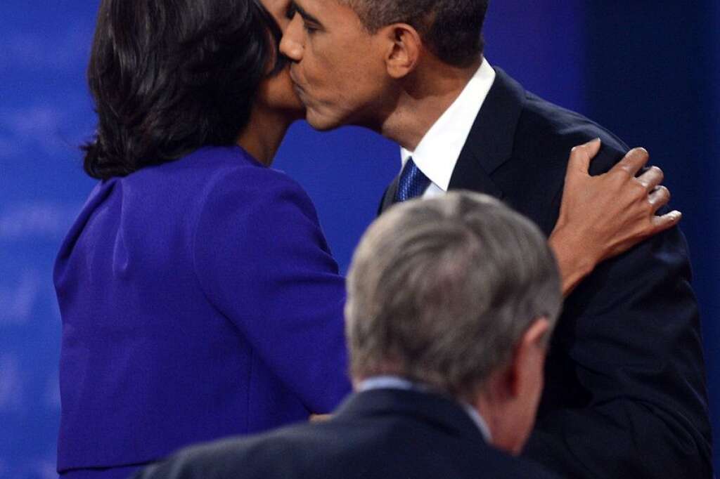 US-VOTE-2012-DEBATE - US President Barack Obama (R) kisses First Lady Michelle Obama in Denver, Colorado, on October 3, 2012 at the end of the first presidential debate with Republican presidential candidate Mitt Romney.    AFP PHOTO / Saul LOEB        (Photo credit should read SAUL LOEB/AFP/GettyImages)