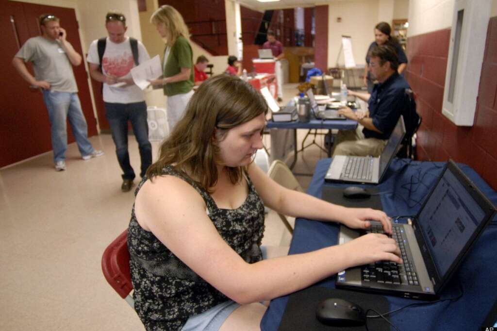 Waldo Canyon Fire evacuee Michelle Hughes uses a computer at Cheyenne Mountain High School evacuation center in Colorado Springs, Colo., on Monday, June 25, 2012. The Waldo Canyon fire, one of at least a half-dozen wildfires in Colorado on Monday, has blackened 5.3 square miles and displaced about 6,000 people since it started Saturday, June 23, but no homes have been destroyed. (AP Photo/Bryan Oller)