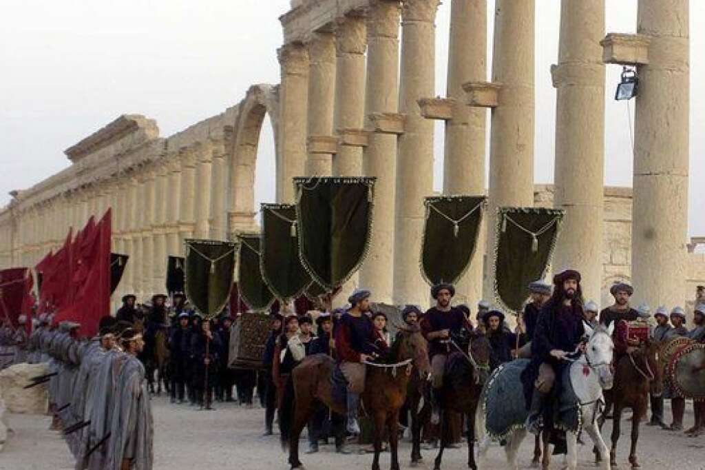 Mideast Syria Palmyra - FILE - In this Sept. 27, 2002, file photo, a symbolic trade caravan representing the prosperous trade during the era of Queen Zanobya 260-273AD attend a show held in the ancient city of Palmyra, some 240 kilometers (150 miles) northeast of Damascus, Syria. A Syrian official said on Sunday that the situation is "fully under control" in Palmyra despite breaches by Islamic State militants who pushed into the historic town a day earlier. (AP Photo/Bassem Tellawi, File)