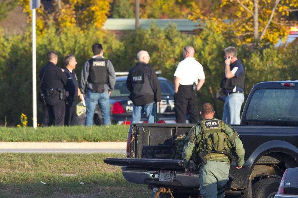 Three People Killed During Shooting At Spa Outside Of Milwaukee - BROOKFIELD, WI - OCTOBER 21:  Police personnel work outside the Azana Salon and Spa where three people were killed and four others wounded after a mass shooting on October 21, 2012 in Brookfield, Wisconsin. The suspected shooter, Radcliffe Haughton, was found dead inside the spa. (Photo by Jeffrey Phelps/Getty Images)