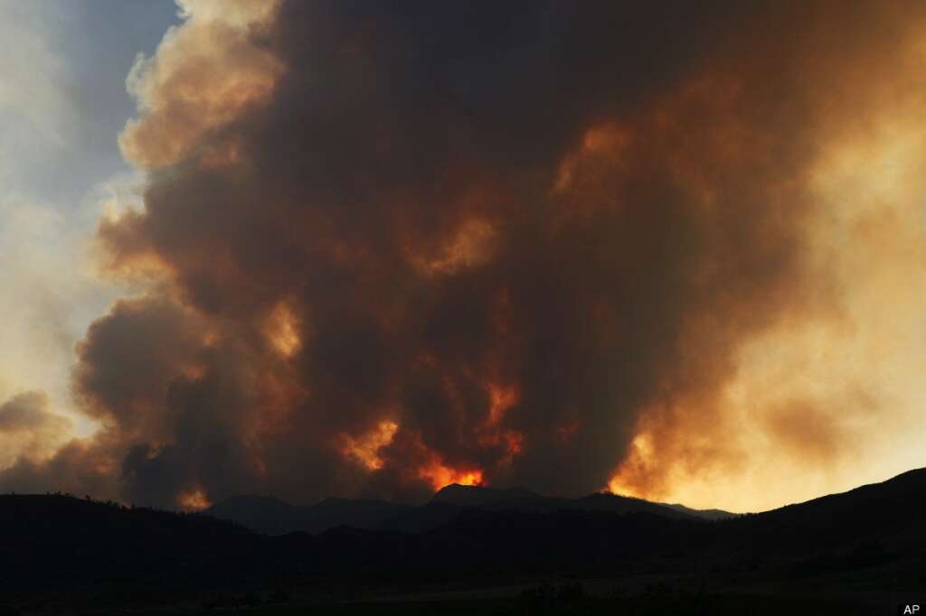 High Park Wildfire - The sun sets behind a plume of smoke from the High Park wildfire near Livermore , Colo., on Friday, June 22, 2012. The fire is burning on more than 68,000 acres west of Fort Collins and has destroyed at least 189 homes (AP Photo/Ed Andrieski)