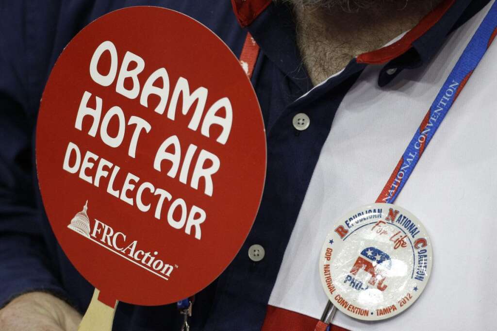 A delegate from Texas holds up an anti-Obama sign during the Republican National Convention in Tampa, Fla., on Tuesday, Aug. 28, 2012. (AP Photo/Charlie Neibergall)