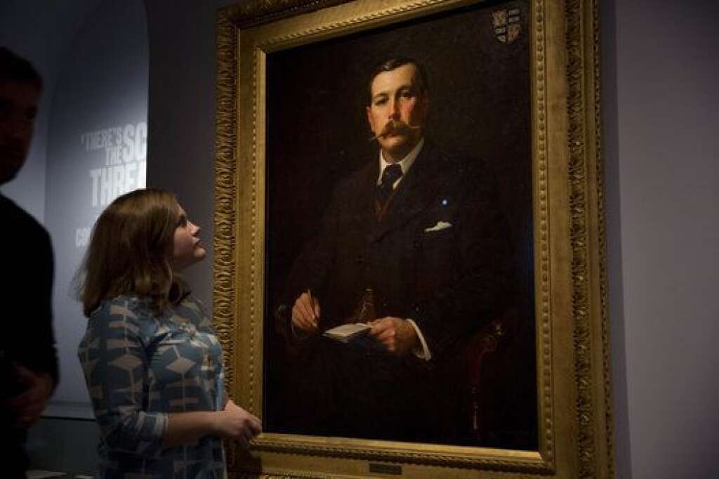- A Museum of London employee poses for photographers next to a 1897 oil on canvas portrait of Sherlock Holmes author Sir Arthur Conan Doyle by illustrator Sidney Paget on display as part of the exhibition "Sherlock Holmes:  The Man Who Never Lived and Will Never Die" at the Museum of London in London, Thursday, Oct. 16, 2014. The exhibition, which opens to the public on Friday, is the largest on the fictional detective created by Scottish author Sir Arthur Conan Doyle to be held in the UK for 60 years.  (AP Photo/Matt Dunham)
