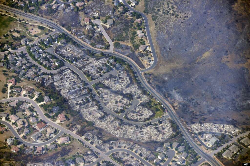 This aerial photo taken on Wednesday, June 27, 2012, shows burned homes in the Mountain Shadows residential area of Colorado Springs, Colo., that were destroyed by the Waldo Canyon wildfire. More than 30,000 have been displaced by the fire, including thousands who frantically packed up belongings Tuesday night after it barreled into neighborhoods in the foothills west and north of Colorado