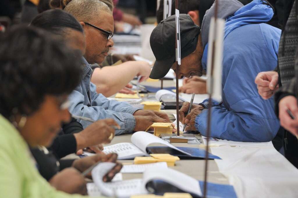 US-VOTE-2012-ELECTION - Election officials verify addresses of voters at the polling station at Metropolitan AME Church  in Washington, DC on November 6, 2012. Americans headed to the polls Tuesday after a burst of last-minute campaigning by President Barack Obama and Mitt Romney in a nail-biting contest unlikely to heal a deeply polarized nation. AFP PHOTO/Mladen ANTONOV        (Photo credit should read MLADEN ANTONOV/AFP/Getty Images)