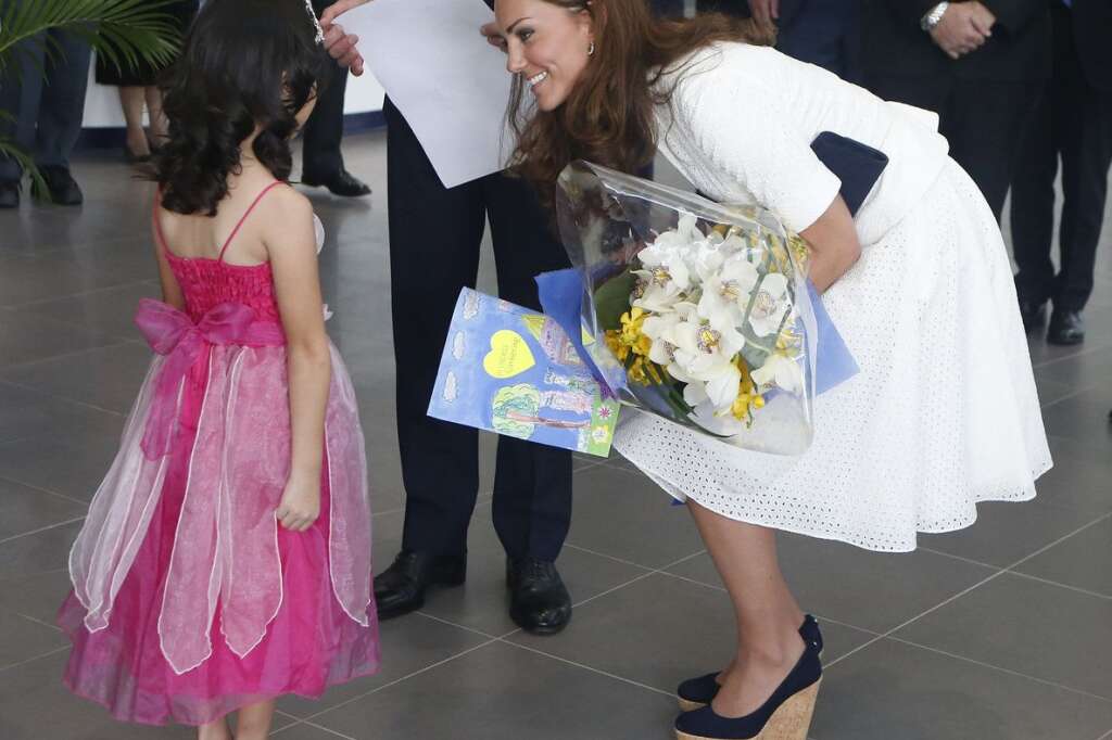 The Duke And Duchess Of Cambridge Diamond Jubilee Tour - Day 2 - SINGAPORE - SEPTEMBER 12:  Catherine, Duchess of Cambridge speaks with four-year-old Maeve Low (L) as she tours the Rolls-Royce Seletar Campus during the Diamond Jubilee tour at Seletar Aerospace Park on September 12, 2012 in Singapore.  (Photo by Danny Lawson - Pool/Getty Images)