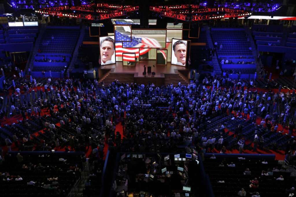 Delegates watch a video presentation during an abbreviated session of the Republican National Convention in Tampa, Fla., on Monday, Aug. 27, 2012. (AP Photo/David Goldman)