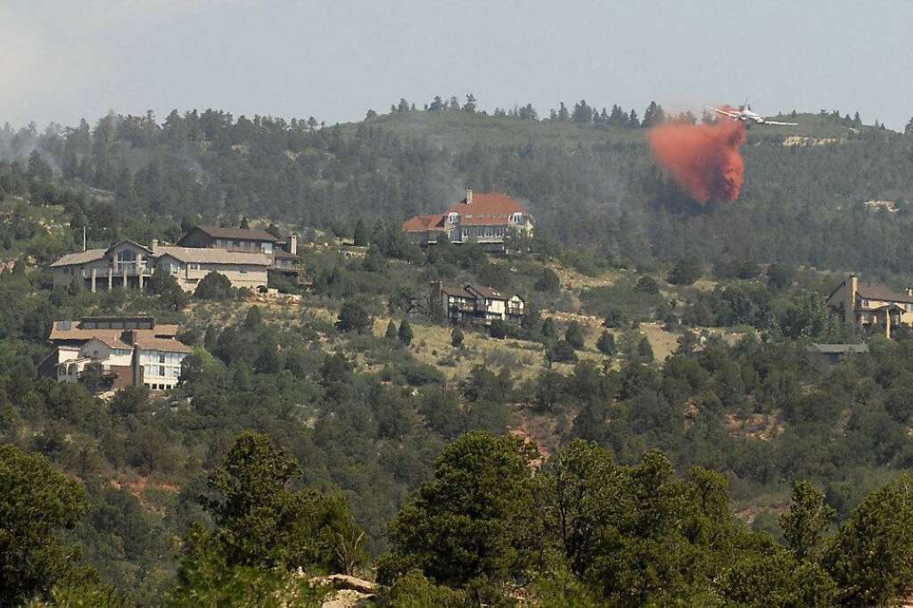 Smoke billows from a wildfire burning near Colorado Springs, Colo., on Sunday, June 24, 2012. The fire erupted and grew out of control to more than 3 square miles early Sunday, prompting the evacuation of more than 11,000 residents and an unknown number of tourists. On Saturday, a blaze destroyed 21 structures near the mountain community of Estes Park. (AP Photo/Bryan Oller)