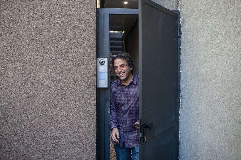 POLAND-JEWS-ARCHITECTURE-HISTORY-ISRAEL-CULTURE - Israeli writer Etgar Keret is seen at the entrance of the Etgar House, allegedly one of the world’s narrowest houses, a day ahead of its official opening on October 19, 2012 in Warsaw, in the former Jewish Ghetto neighbourhood. (WOJTEK RADWANSKI/AFP/Getty Images)