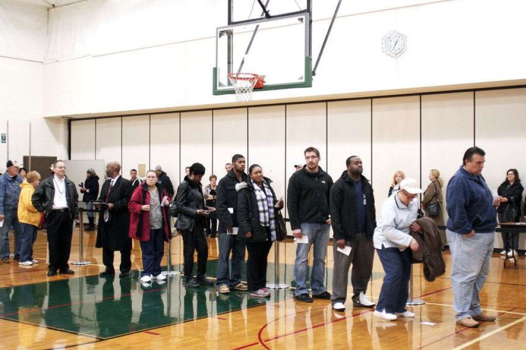 U.S. Citizens Head To The Polls To Vote In Presidential Election - STERLING HEIGHTS, MI, - NOVEMBER 6: U.S. citizens wait in line at a school gymnasium to vote in the presidential election at Carleton Middle School November 6, 2012 in Sterling Heights, Michigan. Recent polls show that U.S. President Barack Obama and Republican presidential candidate Mitt Romney are in a tight race. (Photo by Bill Pugliano/Getty Images)