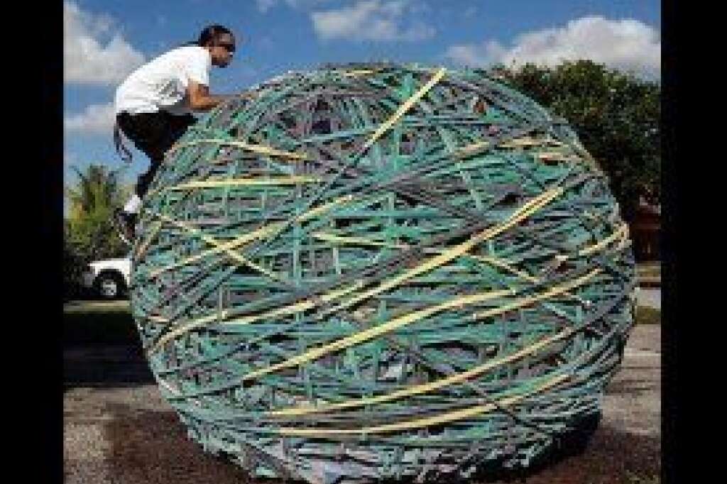 - Joel Waul, 28, climbs on top of his rubber band ball outside his home in Lauderhill, Fla., on Oct. 23, 2009. Waul had spent the past six years building the 6-foot, 7-inch-tall, 9,032-pound behemoth. A team from Ripley's Believe It or Not hauled the ball away on a large, flatbed truck; it was to be featured in one of the company's museums.