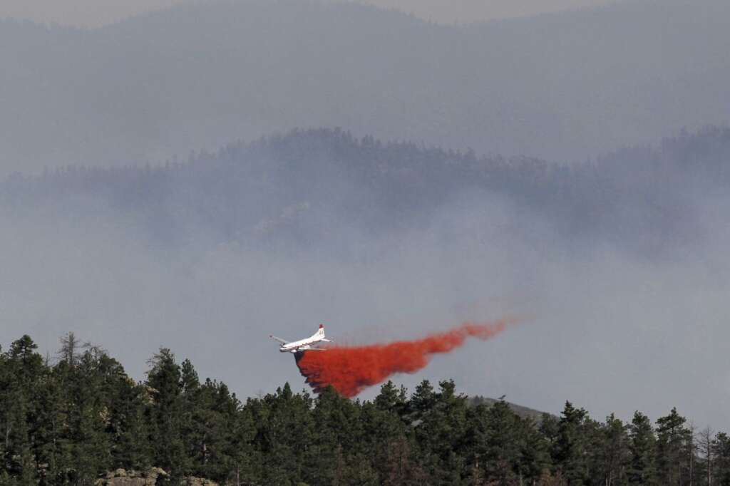 High Park Wildfire - A slurry bomber drops retardant on the High Park wildfire after it crossed to the north side of Poudre Canyon and threatened homes in the Glacier View area near Livermore , Colo., on Friday, June 22, 2012. The fire is burning on more than 68,000 acres west of Fort Collins and has destroyed at least 189 homes (AP Photo/Ed Andrieski)
