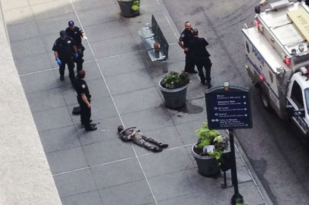 - New York City police approach the lifeless body of Jeffrey Johnson lying on a sidewalk near the Empire State Building in New York following a shooting Friday, Aug. 24, 2012. Police say 58-year-old Johnson, who was laid off from a nearby shop in 2011, shot a former colleague to death near the iconic skyscraper, then randomly opened fire on people nearby before firing on police. New York City Mayor Michael Bloomberg said some of the victims may have been hit by police bullets as police and the gunman exchanged fire. (AP Photo/Guillermo Ratzlaff)