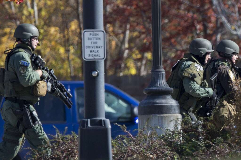 - Police and swat team members respond to a call of a shooting at the Azana Spa in Brookfield, Wis. Sunday , Oct. 21, 2012. Multiple people were wounded when someone opened fire at the spa near the Brookfield Square Mall. Deputies are still looking for the gunman. (AP Photo/Tom Lynn)