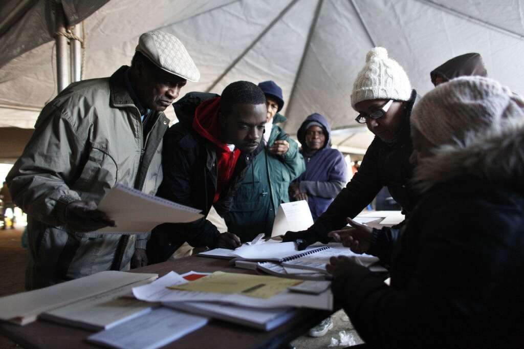 - Voters check in before casting their ballots under a tent at a consolidated polling station for residents of the Rockaways on Election Day, Tuesday, Nov. 6, 2012, in the Queens borough of New York. Election Day turnout was heavy in several storm-ravaged areas in New York and New Jersey, with many voters expressing relief and even elation at being able to vote at all, considering the devastation. (AP Photo/Jason DeCrow)