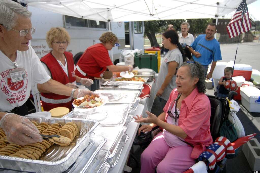Geraldine Webb, of Manitous Springs, Colo., receives lunch at Cheyenne Mountain High School evacuation center in Colorado Springs, Colo., on Monday, June 25, 2012. The Waldo Canyon fire, one of at least a half-dozen wildfires in Colorado on Monday, has blackened 5.3 square miles and displaced about 6,000 people since it started Saturday, June 23, but no homes have been destroyed. (AP Photo/Bryan Oller)