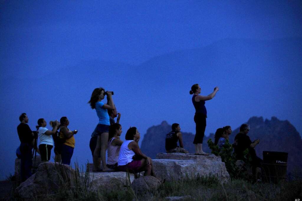 Waldo Canyon Fire - People watch from Mesa Road as a wildfire continues to burn west of Colorado Springs, Colo. on Sunday, June 24, 2012. The fire erupted Saturday and grew out of control to more than 3 square miles early Sunday, prompting the evacuation of more than 11,000 residents and an unknown number of tourists. (AP Photo/The Colorado Springs Gazette, Susannah Kay)