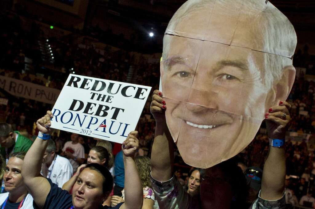 US-VOTE-2012-REPUBLICAN CONVENTION - A supporter of the US Republican presidential contender Ron Paul waves his portrait during a rally at the Sun Dome of the University of South Florida in Tampa, Florida, on August 26, 2012. Thousands of Ron Paul supporters gathered in Sun Dome to show support for their candidate.    AFP PHOTO/MLADEN ANTONOV        (Photo credit should read MLADEN ANTONOV/AFP/GettyImages)