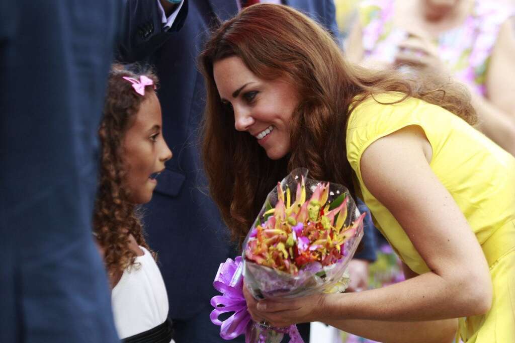 SOLOMONS-BRITAIN-ROYALS - Britain's Catherine, the Duchess of Cambridge talks to a girl at the renovated Commonwealth Street in central Honiara on September 17, 2012. Britain's Prince William and wife Catherine are on a nine-day tour marking Queen Elizabeth II's Diamond Jubilee, and have already visited Singapore and Malaysia before arriving in the Solomon Islands.          AFP PHOTO / Daniel Munoz / POOL        (Photo credit should read DANIEL MUNOZ/AFP/GettyImages)
