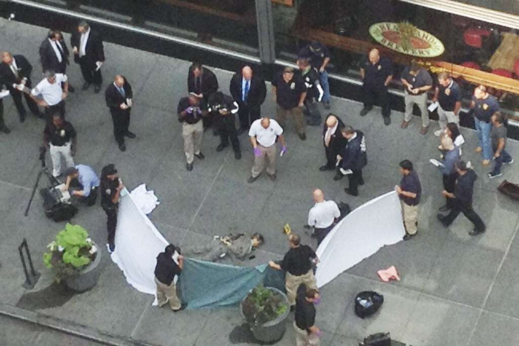 - In this photo made with a cell phone, officials examine the body of gunman Jeffrey Johnson, who was killed by police gunfire after he fatally shot Steven Ercolino, an executive at his former company, outside the Empire State Building, Friday, Aug. 24, 2012, in New York. At least nine bystanders were hit by gunfire in the confrontation. (AP Photo/Lee Weinstein)