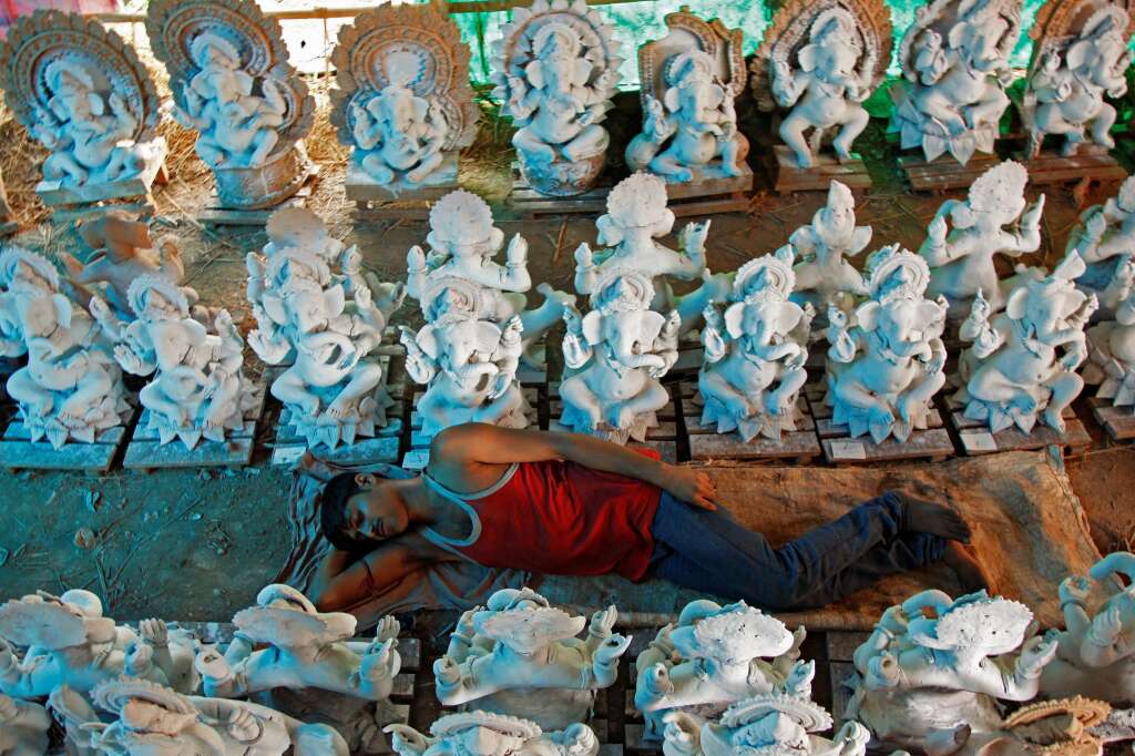 - An artisan rests next to the idols of Hindu god Ganesh at a workshop ahead of the Ganesh Chaturthi festival celebrations, in Chandigarh, India, August 16, 2016.