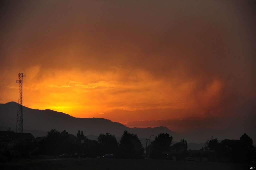 Waldo Canyon Fire - The sun sets as seen from Lower Gold Camp Road as a wildfire continues to burn west of Colorado Springs, Colo. on Sunday, June 24, 2012. The fire erupted Saturday and grew out of control to more than 3 square miles early Sunday, prompting the evacuation of more than 11,000 residents and an unknown number of tourists. (AP Photo/The Colorado Springs Gazette, Susannah Kay)