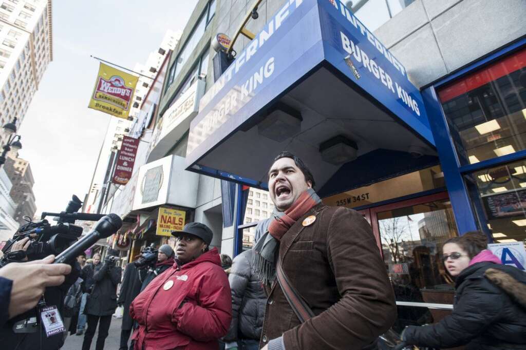 Fast Food Protests In New York City - Saavedra Jantuah, left looks on as Jonathan Westin of New York Communities for Change speaks to protesters at a Burger King restaurant at 34th Street and 8th Avenue in New York as part of the "Fast Food Forward" campaign aimed at giving the workers of fast food companies the right to form a union on Thursday November 29, 2012. (Damon Dahlen, AOL)