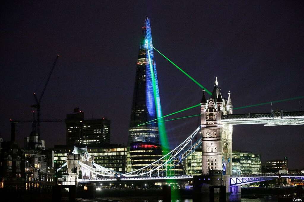 The Shard, Europe's Largest Building Is Unveiled After Completion Of It's Exterior - LONDON, ENGLAND - JULY 05:  Laser lights shine from The Shard over Tower Bridge on July 5, 2012 in London, England. The European Union's highest building designed by Italian architect Renzo Piano, stands at 310 meters tall situated on London's Southbank is formally inaugurated this evening at 10pm with a laser show that will also be streamed live on the internet.  (Photo by Matthew Lloyd/Getty Images)