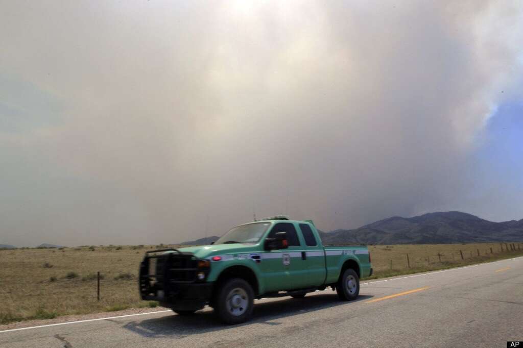 A U.S. Forest Service truck heads down Larimer County Road 74W as a wildfire continues to burn near Livermore, Colo., on Saturday, June 23, 2012. Authorities sent out 992 evacuation notices Friday due to the wildfire burning on more than 100 square miles in northern Colorado as winds pick up. (AP Photo/David Zalubowski)