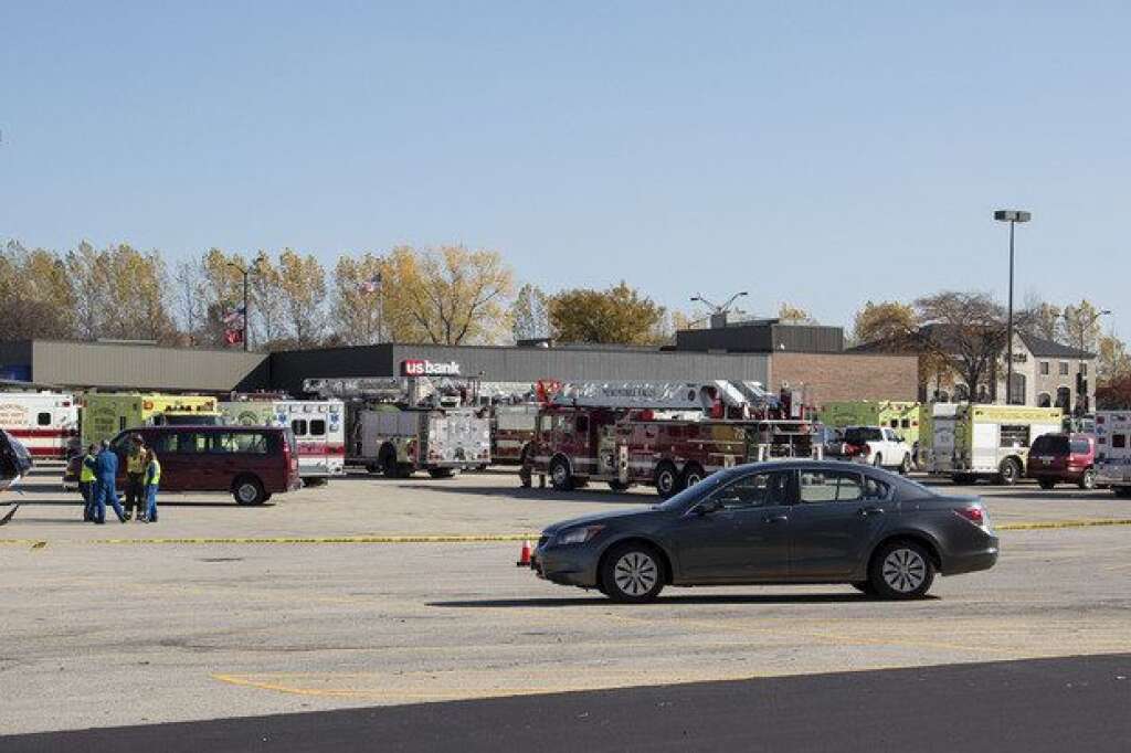 Brookfield Shooting - Emergency vehicles stage across the street from Azana Salon after a shooting in Brookfield, Wis. Sunday , Oct. 21, 2012. Deputies searched Sunday for a shooter after multiple people were wounded when someone opened fire at a spa near a suburban Milwaukee shopping mall(AP Photo/Tom Lynn)