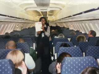 Henderson aboard an AirTrain flight during training for her time as a flight attendant for the airline in 2004.