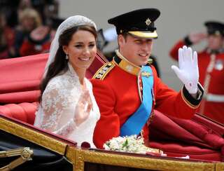 Catherine Middleton and Prince William drive down the Mall in an open carriage on their way to Buckingham Palace after their wedding ceremony at Westminster Abbey