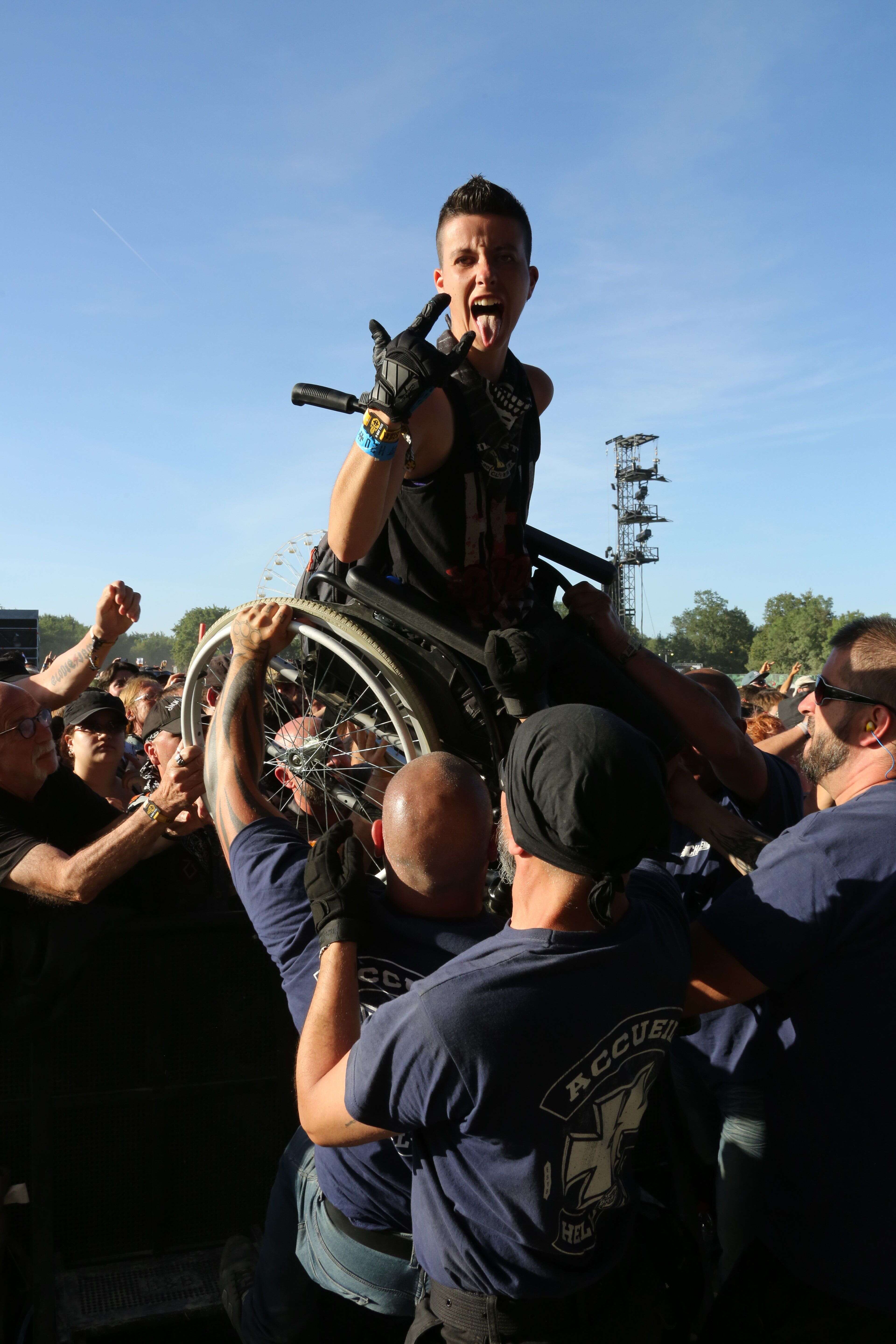 Un festivalier en fauteuil roulant porté par la foule au Hellfest, le 16 juin.