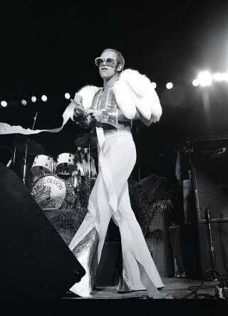 UNITED STATES - OCTOBER 01:  Photo of Elton JOHN; Elton John performing on stage, full length, fur  (Photo by Robert Knight Archive/Redferns)